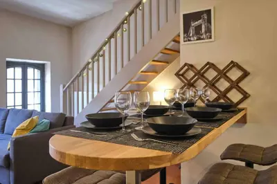 a table with bowls and wine glasses on it at CENTRE VILLE Appartement 75m2, avec 3 chambres in Carcassonne