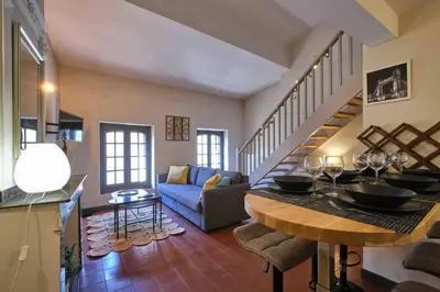 a living room with a couch and a staircase at CENTRE VILLE Appartement 75m2, avec 3 chambres in Carcassonne