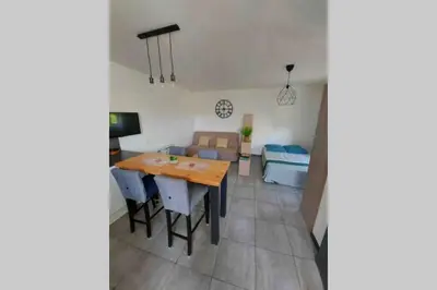 a living room with a table and a couch at Location studio entre garrigue et mer in Vinassan