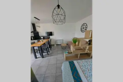 a living room with a couch and a table at Location studio entre garrigue et mer in Vinassan
