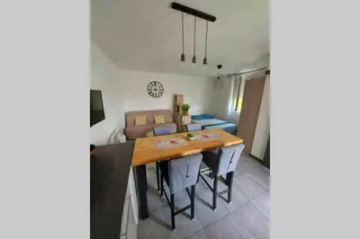 a kitchen and living room with a table and a couch at Location studio entre garrigue et mer in Vinassan