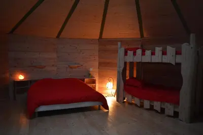a bedroom with two bunk beds in a cabin at Les Ecuries de la Sabatarié in Cambounès