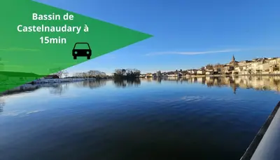 a view of a town from the water with a bus at LE CONCORDE-WIFI-Clim-Parking-3étoiles-OcKeys in Bram