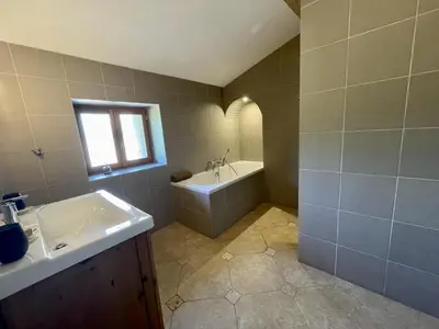 a bathroom with a sink and a bath tub at Le Domaine de La Tuilerie - Gite de charme en bord de riviere avec piscine in Serviès-en-Val
