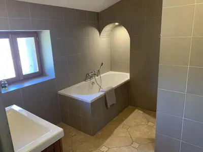 a bathroom with a bath tub and a sink at Le Domaine de La Tuilerie - Gite de charme en bord de riviere avec piscine in Serviès-en-Val