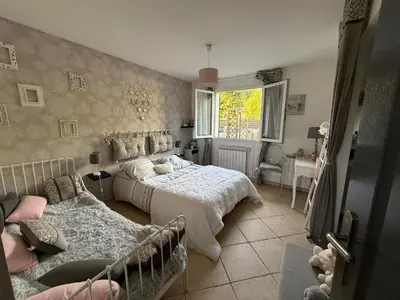 a bedroom with two beds and a window at Mon rêve in Les Martys