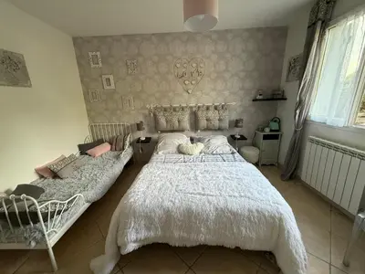 a bedroom with a large bed and a couch at Mon rêve in Les Martys