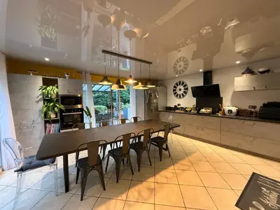 a large kitchen with a long table and chairs at Mon rêve in Les Martys