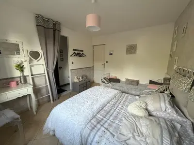 a bedroom with a white bed and a desk at Mon rêve in Les Martys