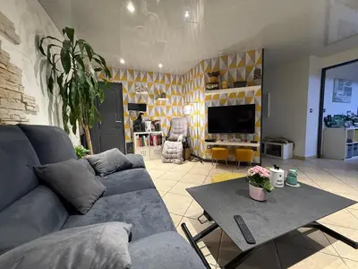 a living room with a couch and a table at Mon rêve in Les Martys