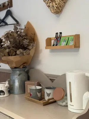 a kitchen counter with cups and a vase on it at Mon rêve in Les Martys