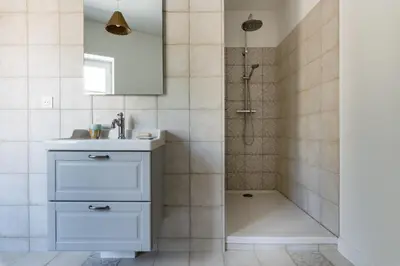 a bathroom with a sink and a shower at Maison d'hôtes ÔVillage in Ouveillan