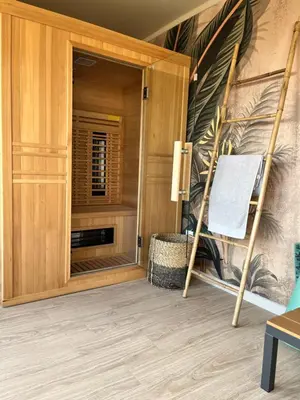 a room with a chair and a mirror at Maison d'hôtes ÔVillage in Ouveillan