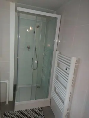 a shower in a bathroom with a glass shower stall at studio au calme wifi 600m centre ville parking privé in Castres