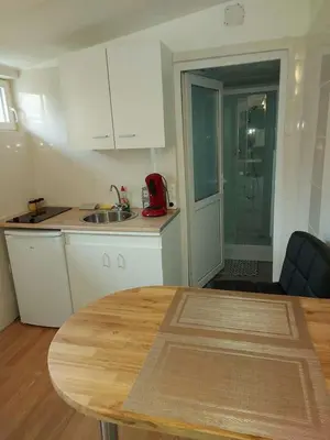 a kitchen with a table and a kitchen with a sink at studio au calme wifi 600m centre ville parking privé in Castres