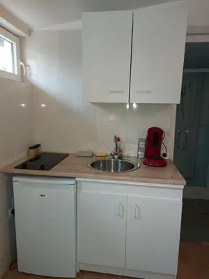 a kitchen with a sink and a counter top at studio au calme wifi 600m centre ville parking privé in Castres