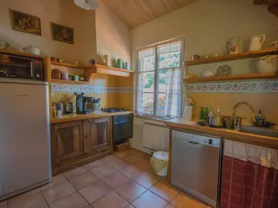 a kitchen with a sink and a refrigerator at Gite des Kathares in Montferrier