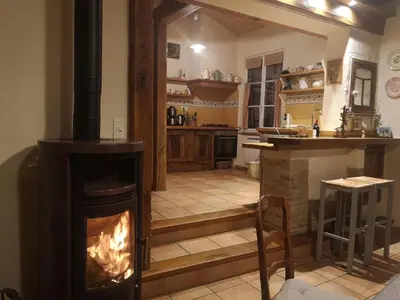 a kitchen with a wood stove in a room at Gite des Kathares in Montferrier