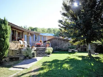 a house with a yard with a table and chairs at Gite des Kathares in Montferrier