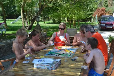a group of people sitting around a picnic table at Domaine Las Brugues in Saint-Papoul
