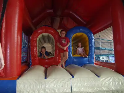 two children are playing in a bounce house on a water slide at Domaine Las Brugues in Saint-Papoul