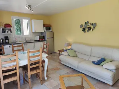 a living room with a white couch and a table at Domaine Las Brugues in Saint-Papoul