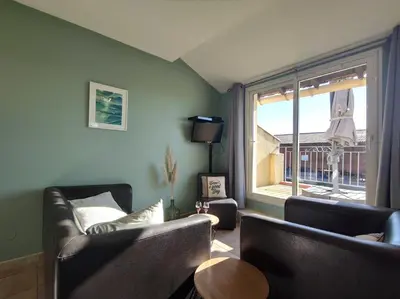 a living room with two couches and a window at Domaine Las Brugues in Saint-Papoul