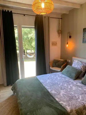 a bedroom with a bed and a large window at VILLA LOUNA 4 étoiles in Ventenac-Cabardès