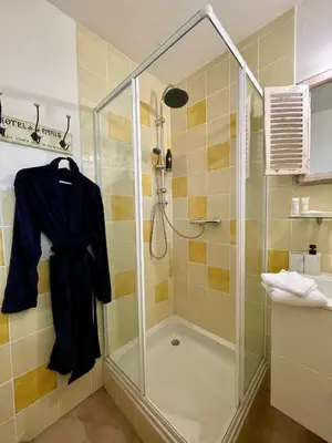 a shower with a glass shower stall in a bathroom at Marie Jean Chambre d'hôtes & Gîte in Oupia