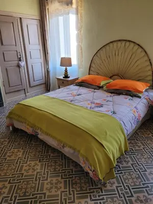 a bedroom with a large bed with orange pillows at La Sorga de Vida in Quarante