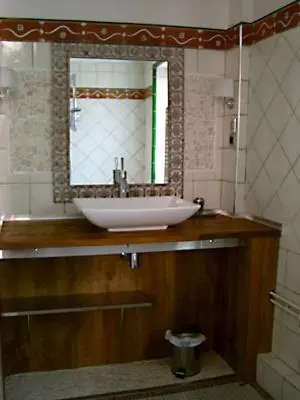 a bathroom with a sink and a mirror at La Sorga de Vida in Quarante