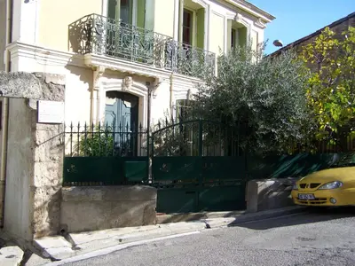 a yellow car parked in front of a building at La Sorga de Vida in Quarante