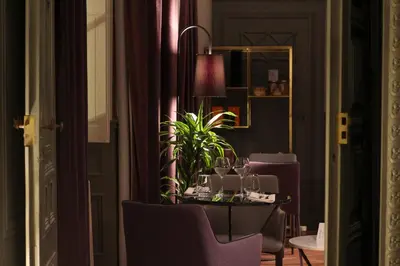a table with wine glasses and a plant on it at Château de Roquefoulet Luxury Guesthouse & Spa in Montgeard