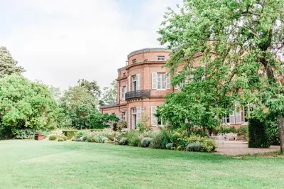 an old brick building with a lawn in front of it at Château de Roquefoulet Luxury Guesthouse & Spa in Montgeard