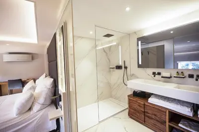 a bathroom with a sink and a shower at Château de Roquefoulet Luxury Guesthouse & Spa in Montgeard