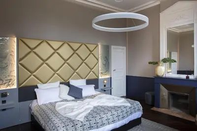 a bedroom with a bed with a large headboard at Château de Roquefoulet Luxury Guesthouse & Spa in Montgeard