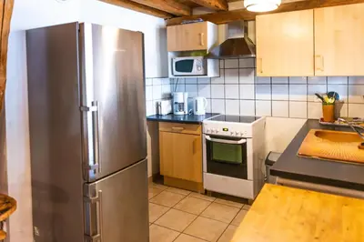 a kitchen with a stainless steel refrigerator at GITE AUTOMNE in Le Soulié