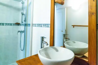 a bathroom with two sinks and a shower at GITE AUTOMNE in Le Soulié