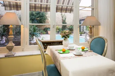 a dining room with a table and a window at Carcassonne Bed and Breakfast du Palais in Carcassonne