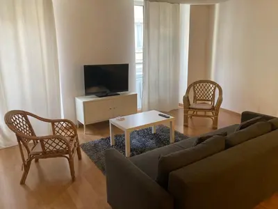 a living room with a couch and chairs and a tv at Ravissant Appartement T3 hypercentre de Mazamet in Mazamet