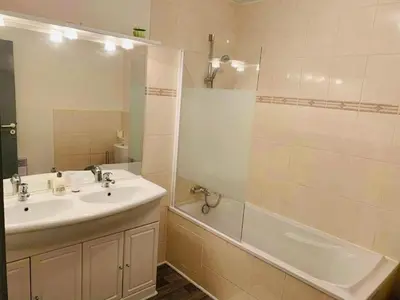 a bathroom with a sink and a shower and a tub at Ravissant Appartement T3 hypercentre de Mazamet in Mazamet