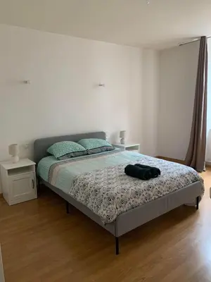a bedroom with a bed with a backpack on it at Ravissant Appartement T3 hypercentre de Mazamet in Mazamet
