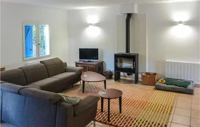 a living room with a couch and a fireplace at 2 Bedroom Awesome Home In Berlou in Berlou