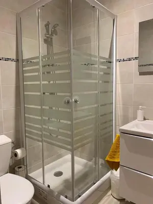 a shower with a glass door in a bathroom at La Liberté in Narbonne