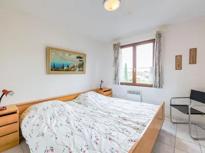 a bedroom with a bed and a desk and a window at Holiday Home La Maison d'Antoine by Interhome in Salles-d'Aude