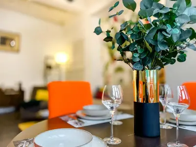a table with glasses and a vase with a plant at RétroMirabeau 