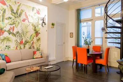 a living room with a couch and a table at RétroMirabeau 