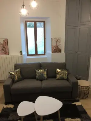 a living room with a couch and a table at Le Montréalais in Montréal