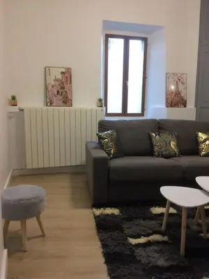 a living room with a couch and a table at Le Montréalais in Montréal