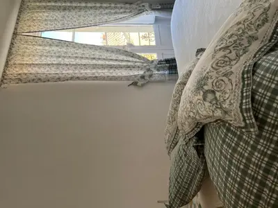 a bedroom with a pillow and a window at Appart République in Narbonne